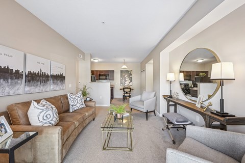 A living room with a brown couch and a coffee table.