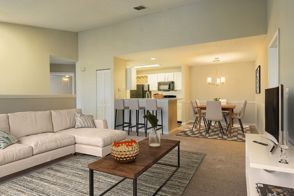 a living room and dining room with a couch and a table