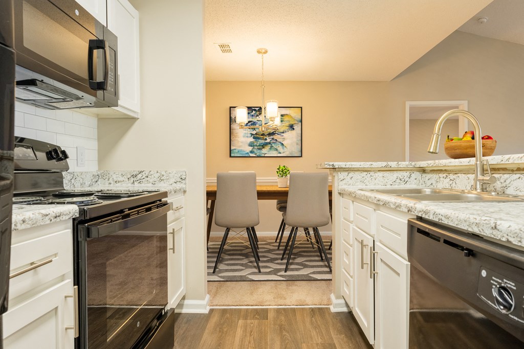 an open kitchen and dining room with a table and chairs