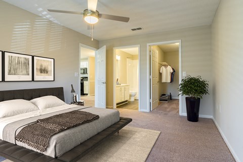 a bedroom with a bed and a ceiling fan