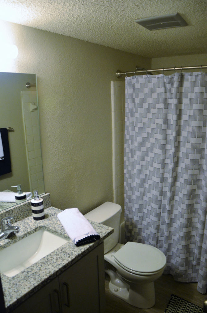 a small bathroom with a shower toilet and sink
