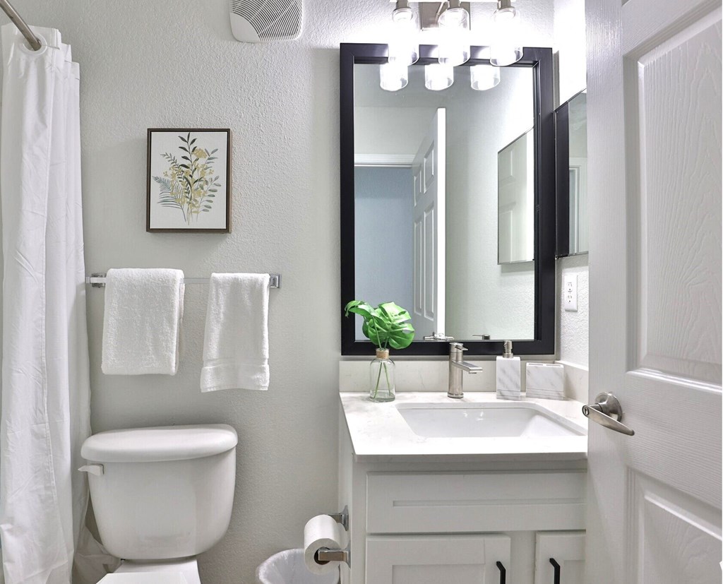 a small bathroom with a toilet sink and a mirror