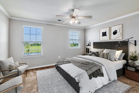 a bedroom with a bed and a ceiling fan