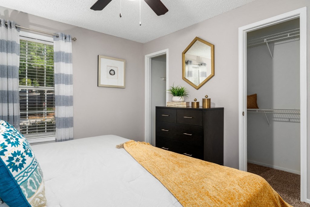 Carpeted bedroom with ceiling fan, and large closets at Summerchase at Riverchase in Hoover, Alabama