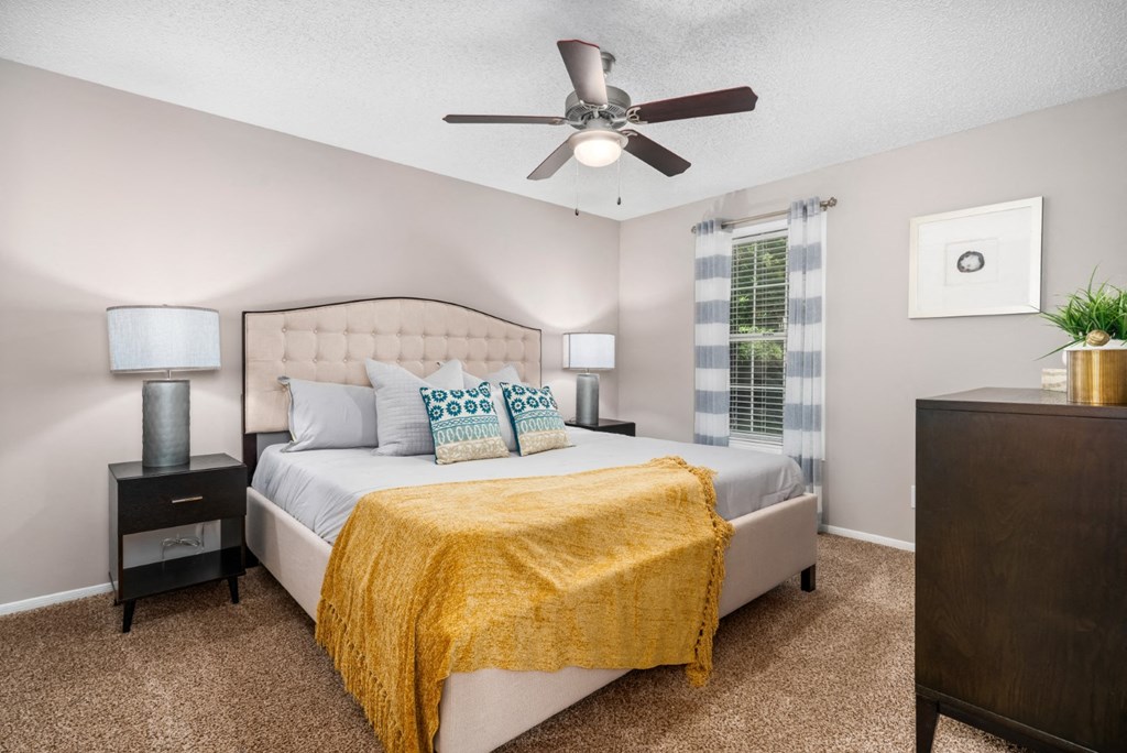Carpeted bedroom with ceiling fan, and window at Summerchase at Riverchase in Hoover, Alabama