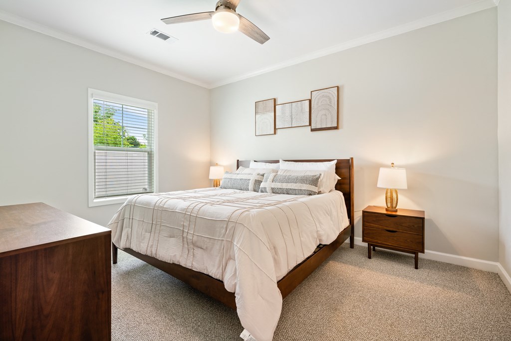 a bedroom with a bed and a ceiling fan