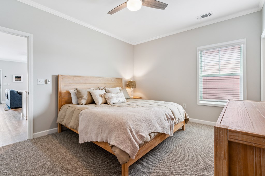 a bedroom with a bed and a ceiling fan