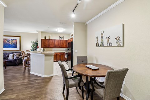 A dining room with a table and chairs.