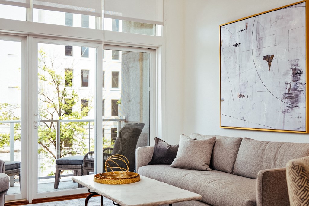 a living room with a couch and a table and a balcony at 20 Midtown, Birmingham, Alabama