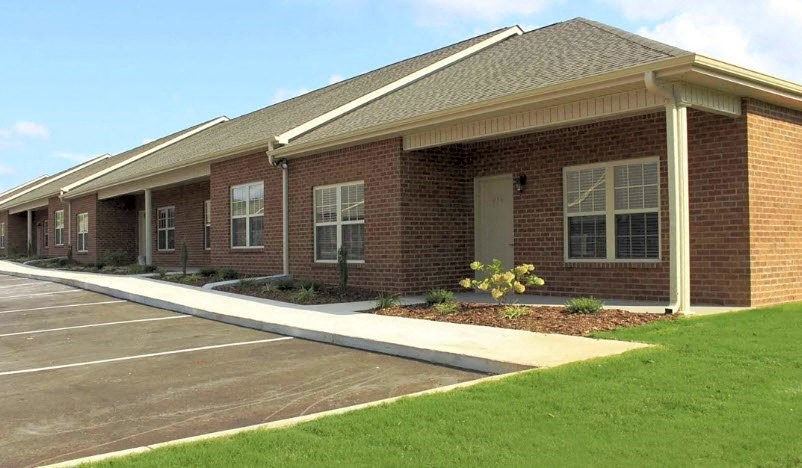 Apartment building with private front porch at Breckenridge Apartments in Tuscumbia, AL