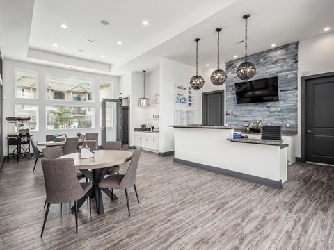 a kitchen and dining area with a table and chairs