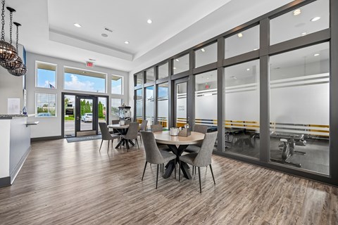 A modern dining room with a large table and chairs.