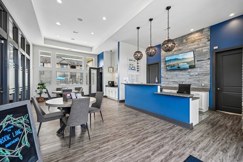 A modern kitchen with a dining table and chairs.