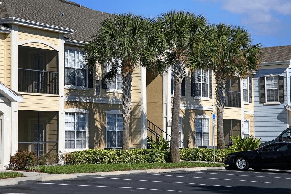 a building with palm trees in front of it