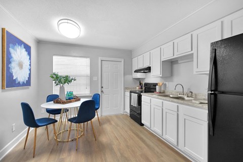 an open kitchen and dining room with a table and chairs