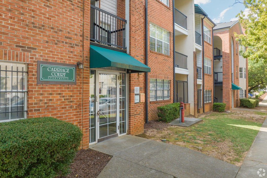 The image shows a brick building with a green awning and a sign that reads "Cadence Court."