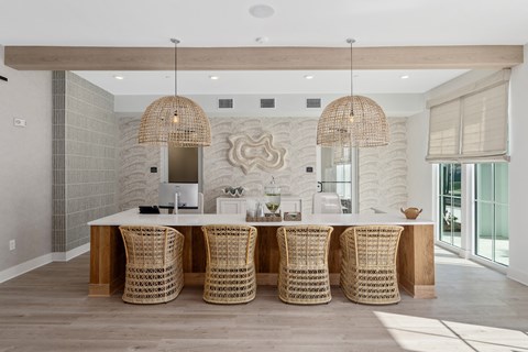A dining room with a white table and chairs with a wooden top.
