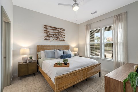A bedroom with a large bed and a wooden headboard.