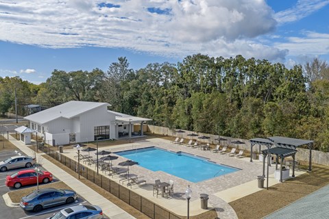 A large white building with a pool in front.
