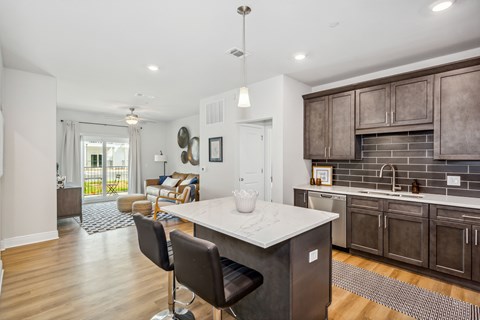 A kitchen with a white counter top and brown cabinets.