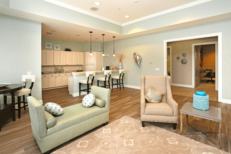 a living room and dining room with a kitchen