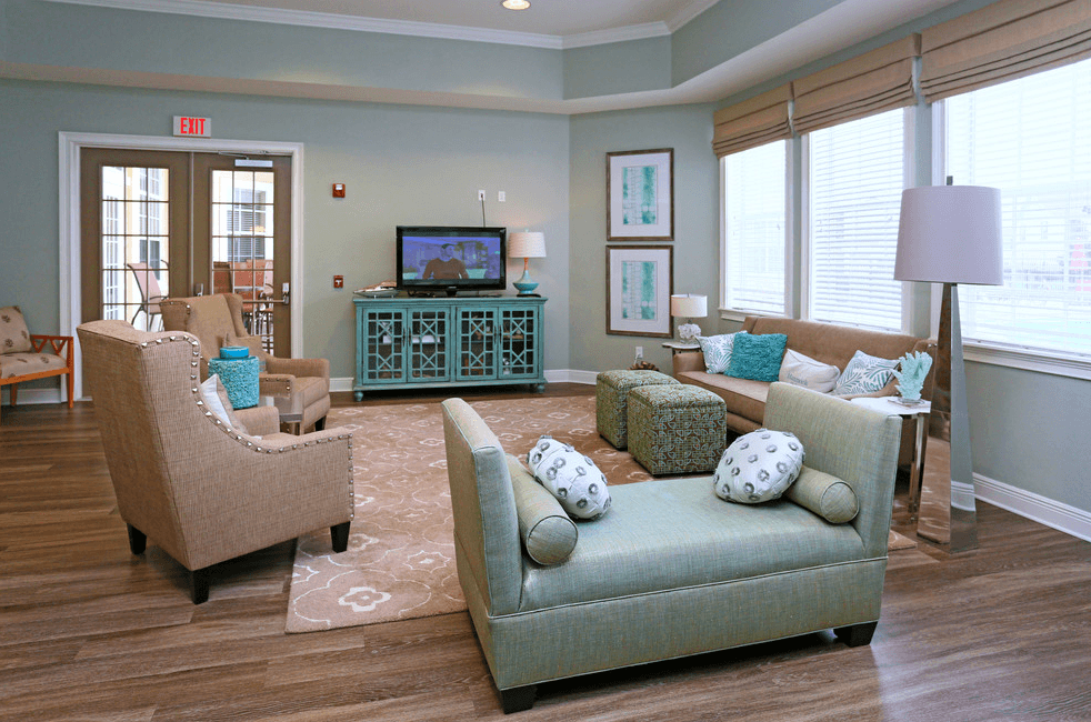 a living room with couches and chairs and a television