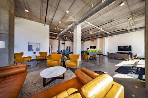 A modern living room with yellow chairs and a white coffee table.