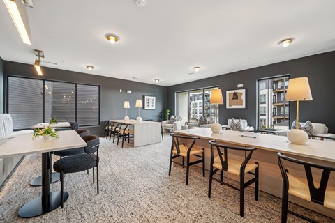 A modern dining area with a long table and chairs.
