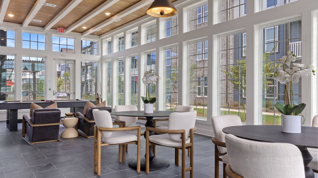 A large room with a long table and chairs.