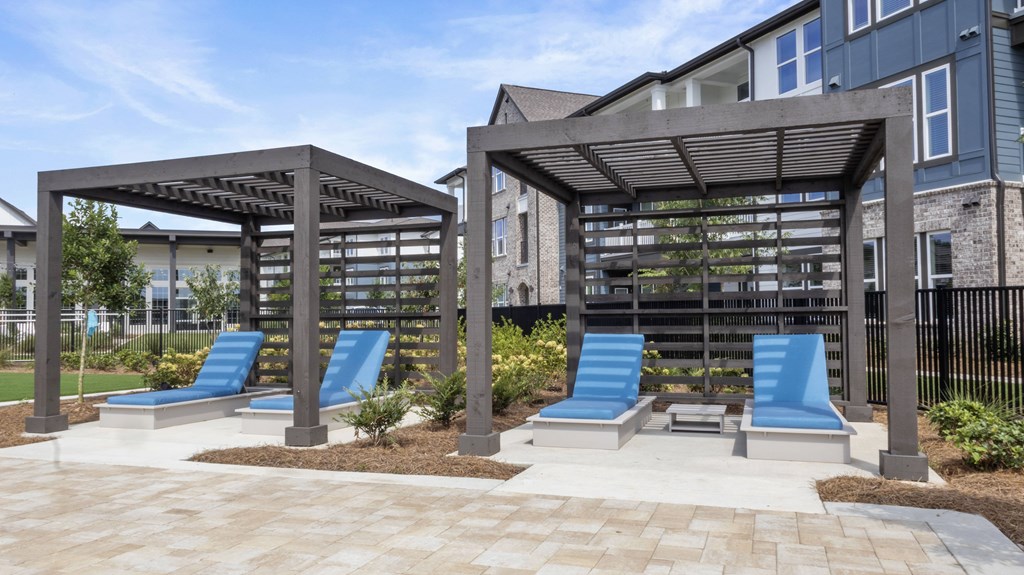 A park with a blue slide and a canopy.
