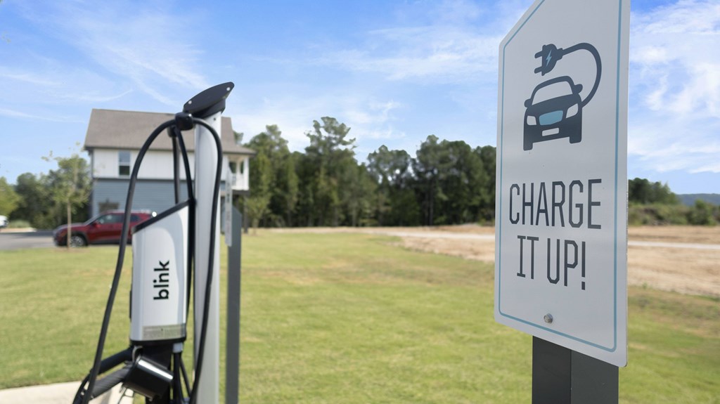 A charging station sign with the words "Charge It Up!" is displayed.