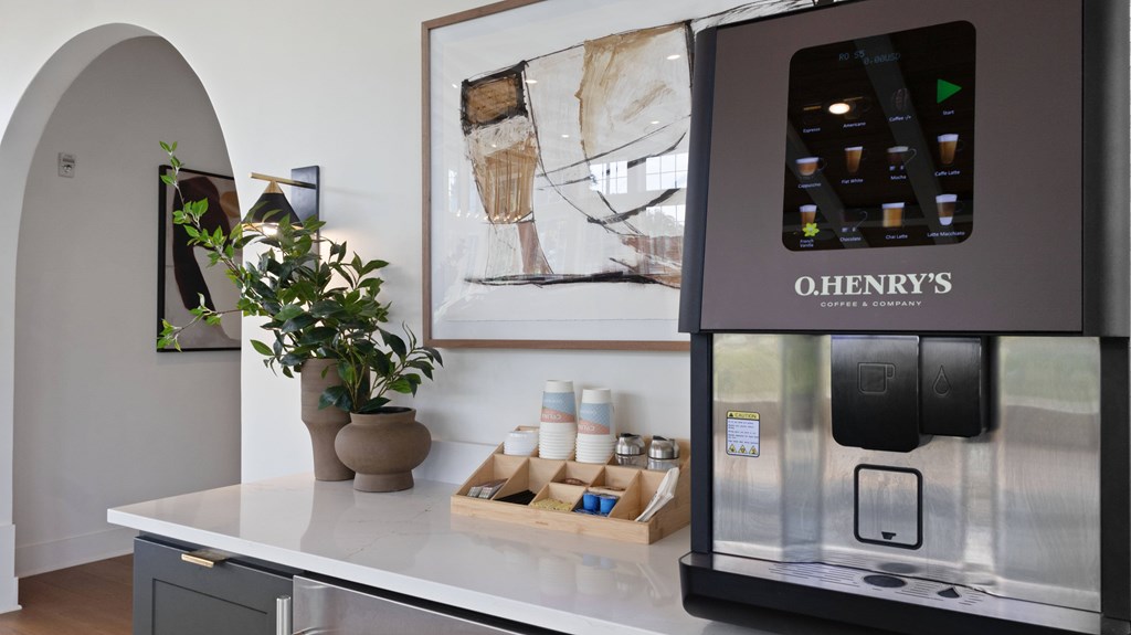 A modern kitchen with a Henry's coffee machine on the counter.