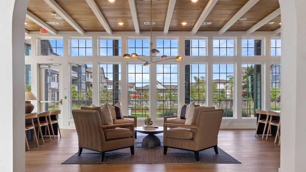 A living room with a large window and a wooden floor.