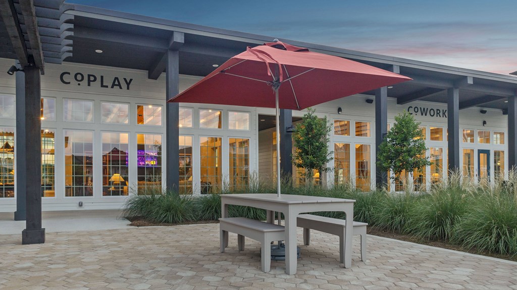 A bench is in front of a building with a sign that says "COPLAY".