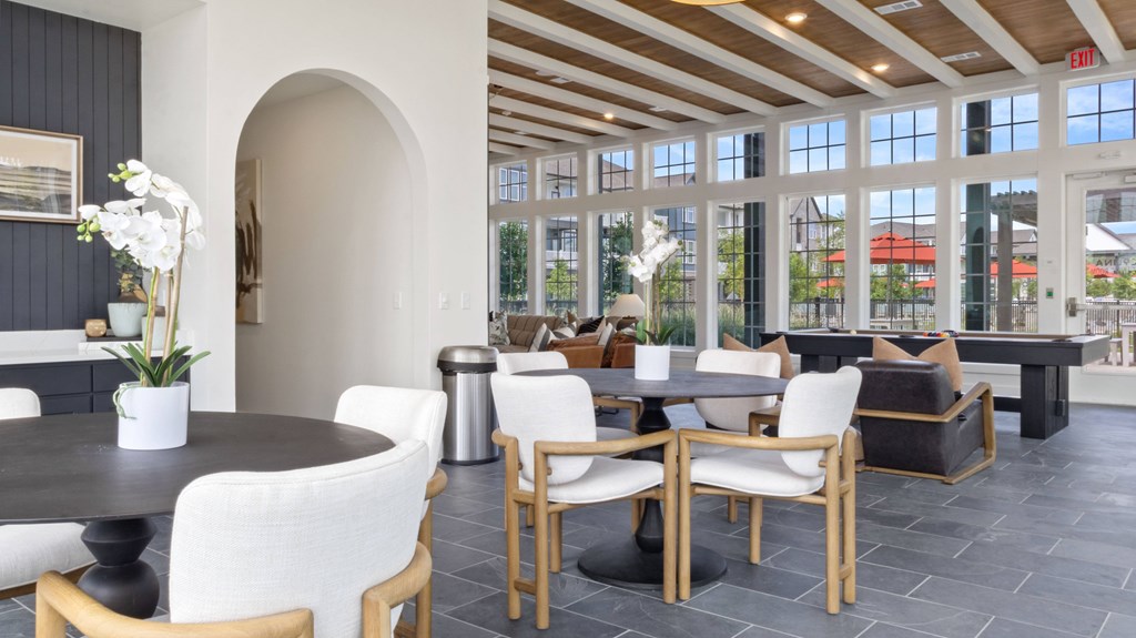 A dining room with a table and chairs.