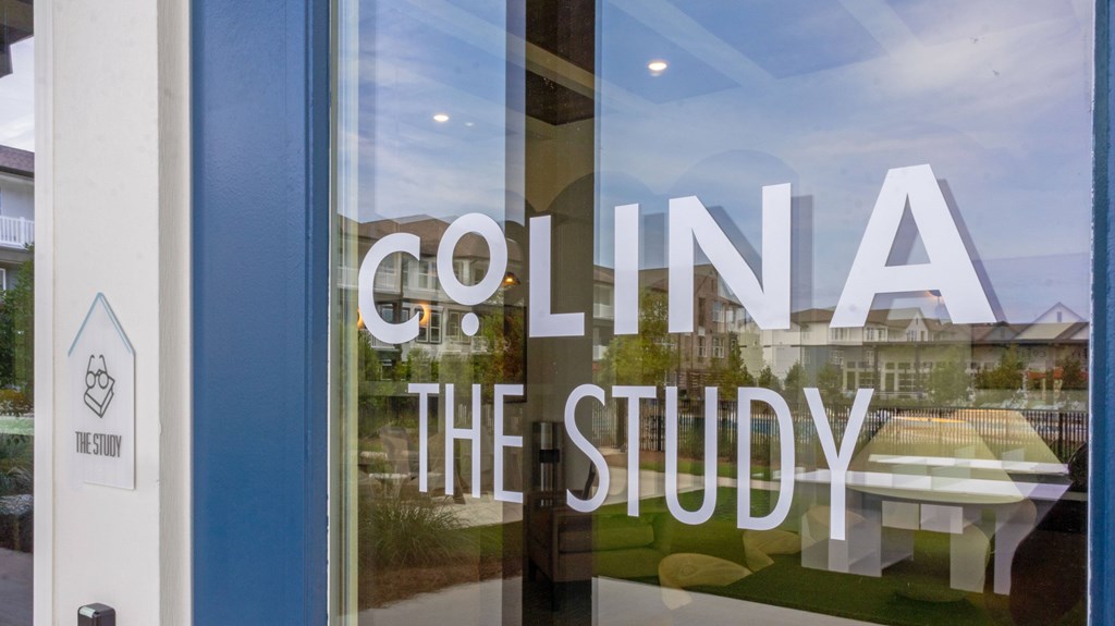 A glass window with the word Colina on it.