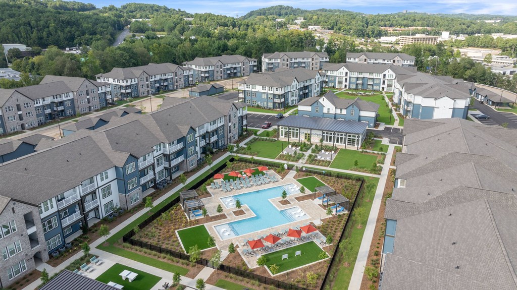 A large apartment complex with a swimming pool and a playground.