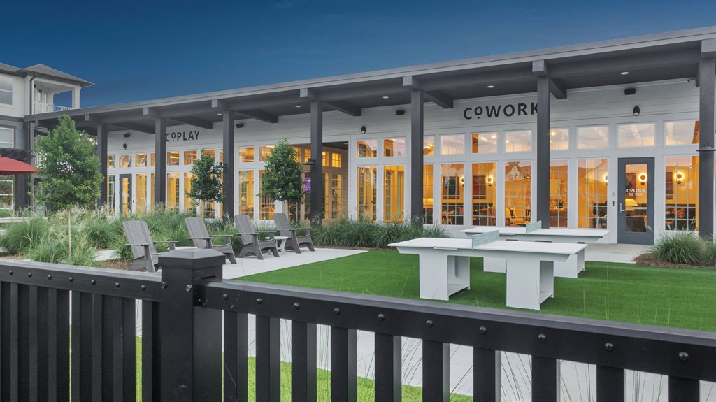 A modern building with a sign that reads "COWORK" is shown.