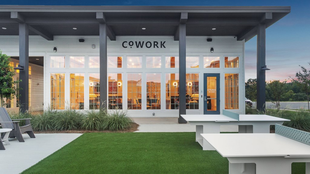 A modern building with the word COWORK on the front.