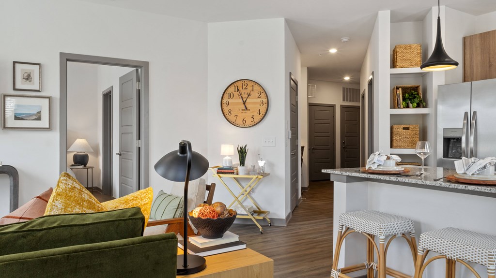 A living room with a green couch and a wooden coffee table.