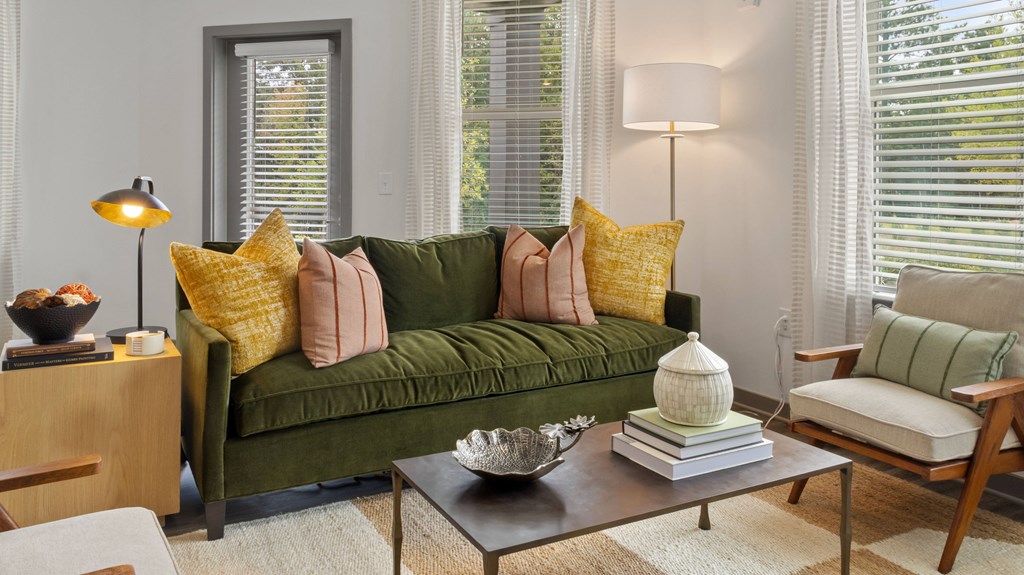 A living room with a green couch and a coffee table.