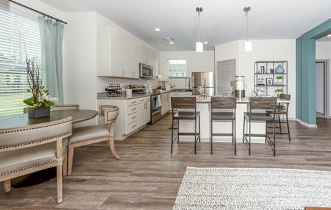a kitchen and dining room with a table and chairs