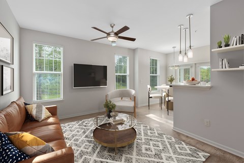 A living room with a brown leather couch and a white armchair.