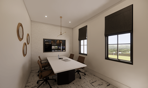 A conference room with a white table and brown chairs.