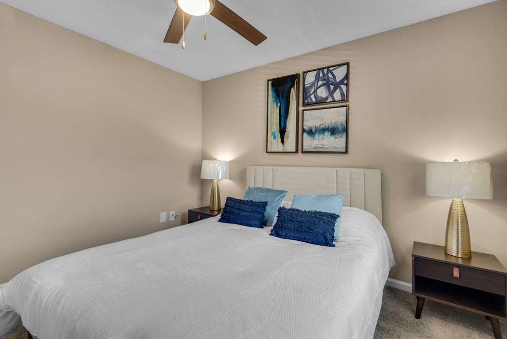 A bedroom with carpet flooring and ceiling fan at Crystal Lake in Pensacola, Florida.