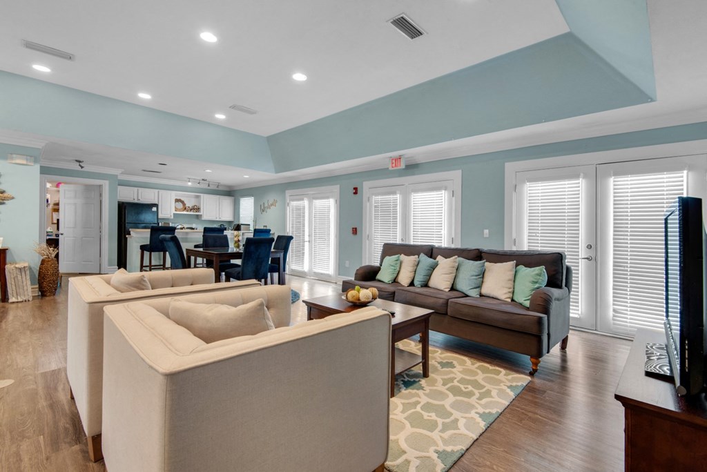Clubhouse with an open floorplan including lounge areas and a community kitchen at Crystal Lake in Pensacola, Florida.