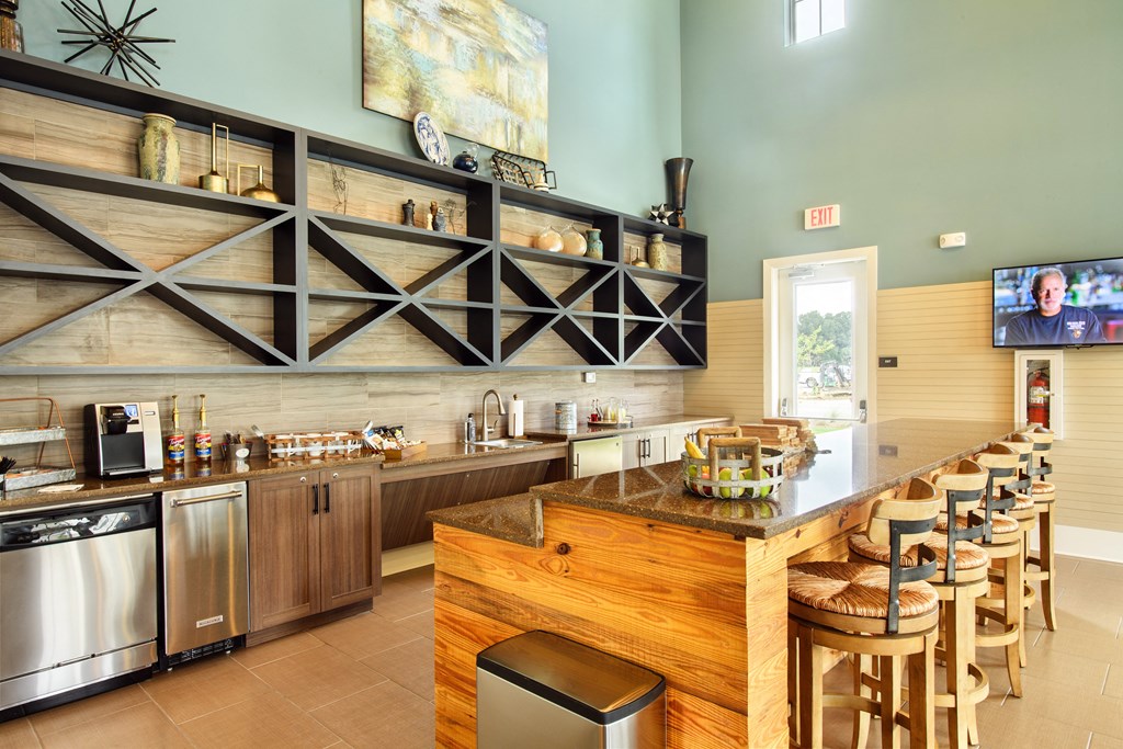 a kitchen with a bar and stools in a restaurant