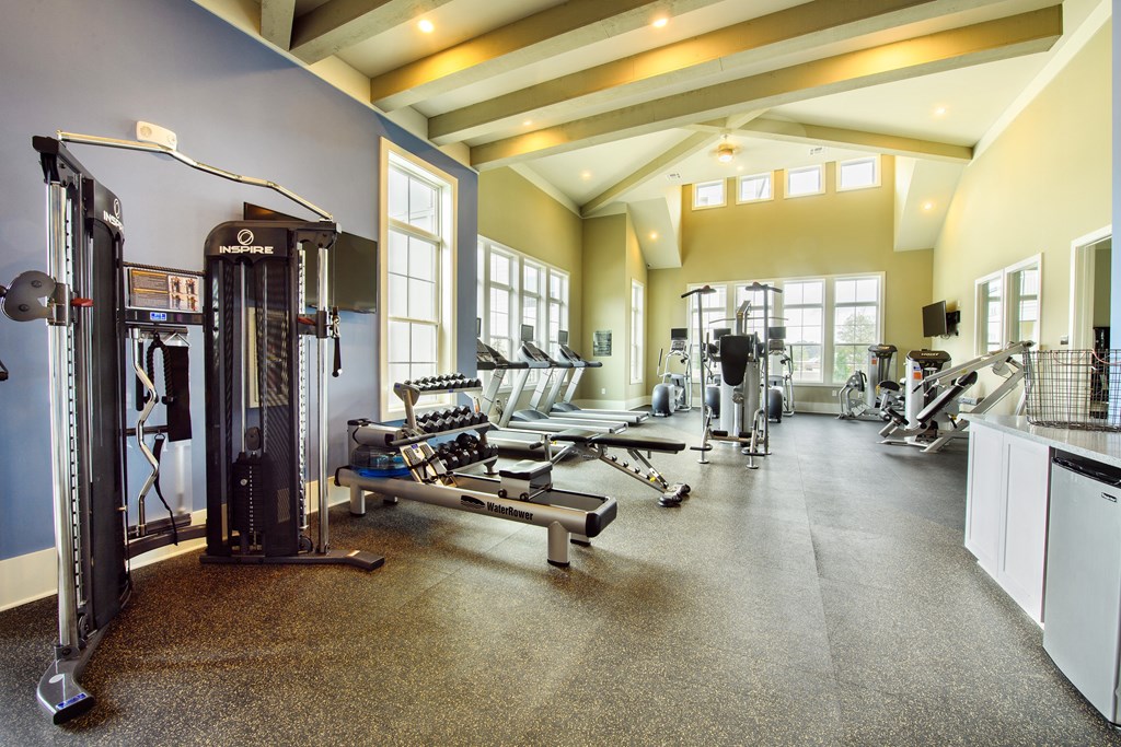 a large fitness room with weights and other exercise equipment