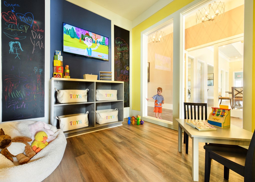 a playroom with a child walking out of a door