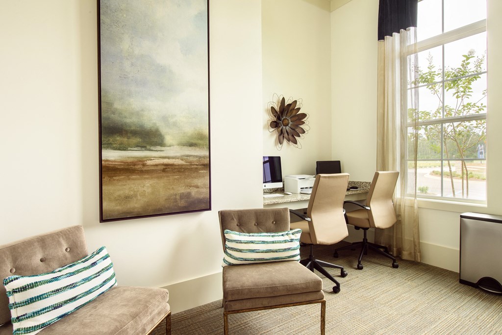 a conference room with chairs and a desk with a computer